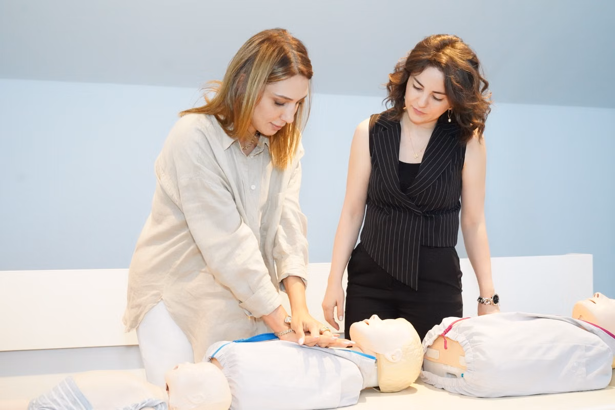 learners practising CPR on training manikins