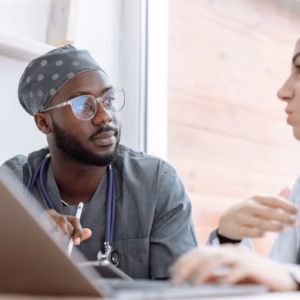 two healthcare professionals discussing safe care practice