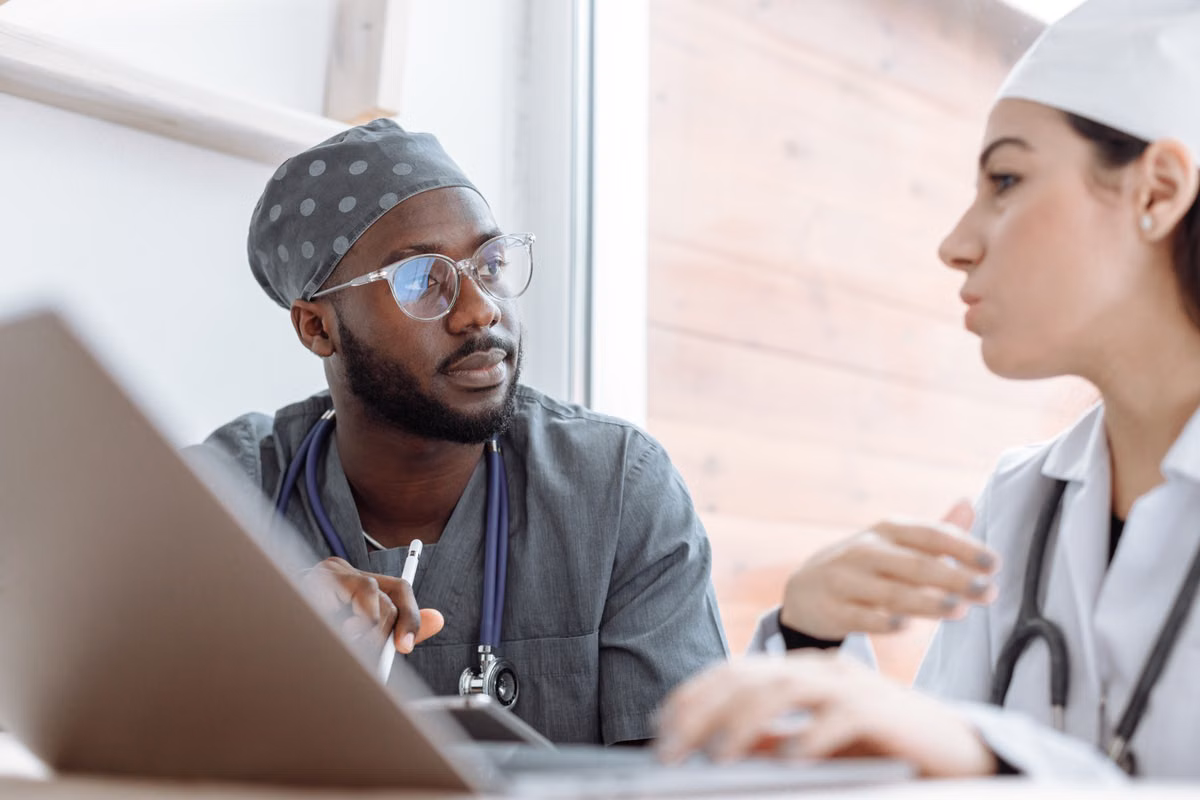 two healthcare professionals discussing safe care practice