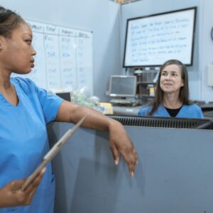 healthcare professionals discussing safe care practice in a clinical setting