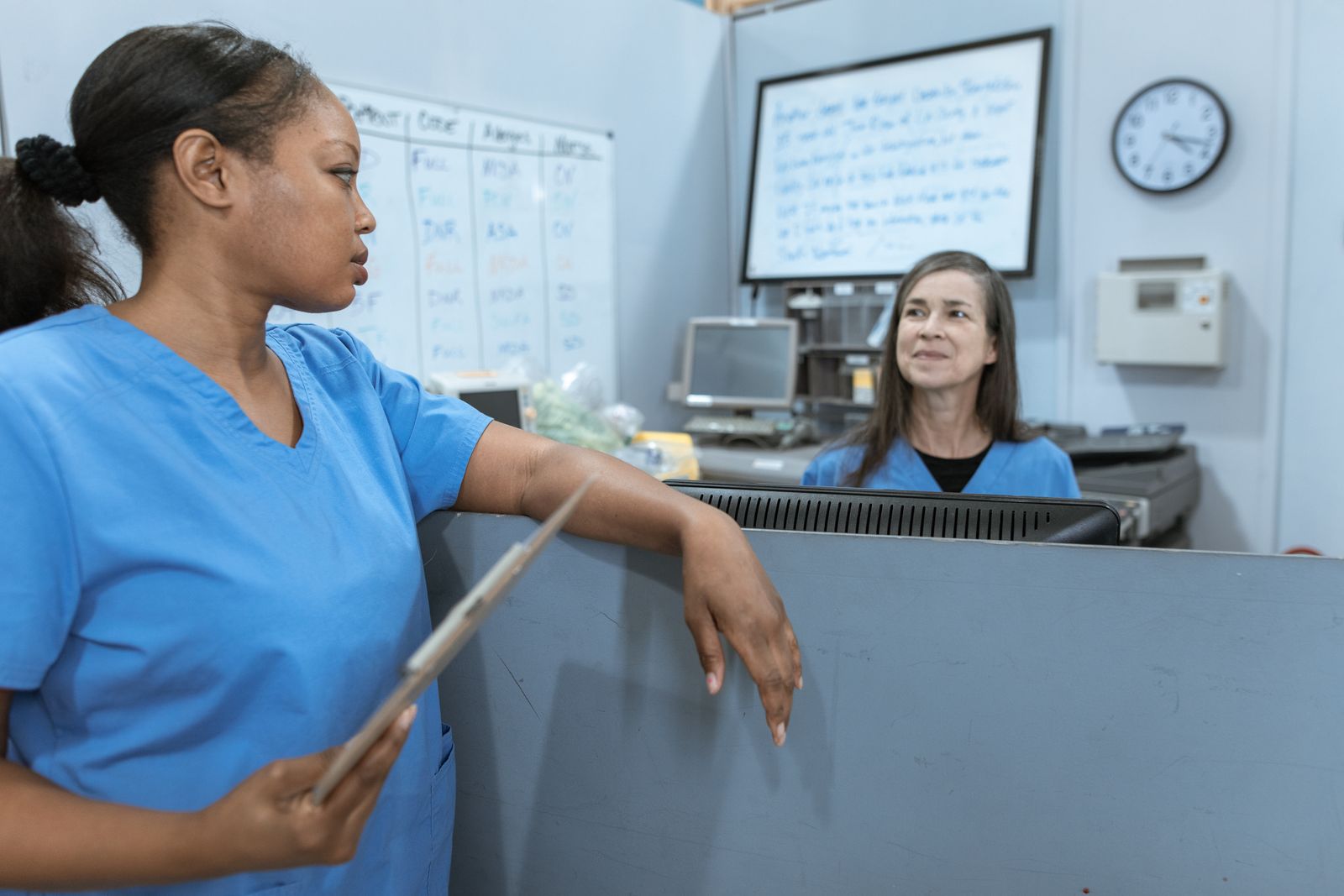 healthcare professionals discussing safe care practice in a clinical setting